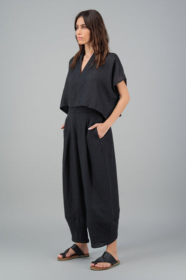 Woman wearing black linen pants and black linen top